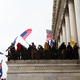 A group of pro-Trump protesters wave flags from a platform on the Capitol Building on January 6, 2021 in Washington, DC. A pro-Trump mob stormed the Capitol, breaking windows and clashing with police officers.